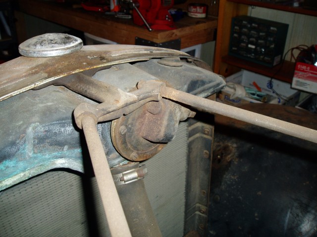 Saturday 9/30/2006. The radiator is sitting on sheet metal that blocks access to nuts holding the fenders on. So it needs to come out first.