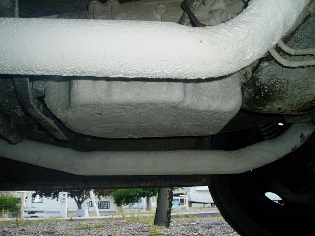 Underside of the motor home. That's not insulation on the exhaust pipes, it's caked salt.