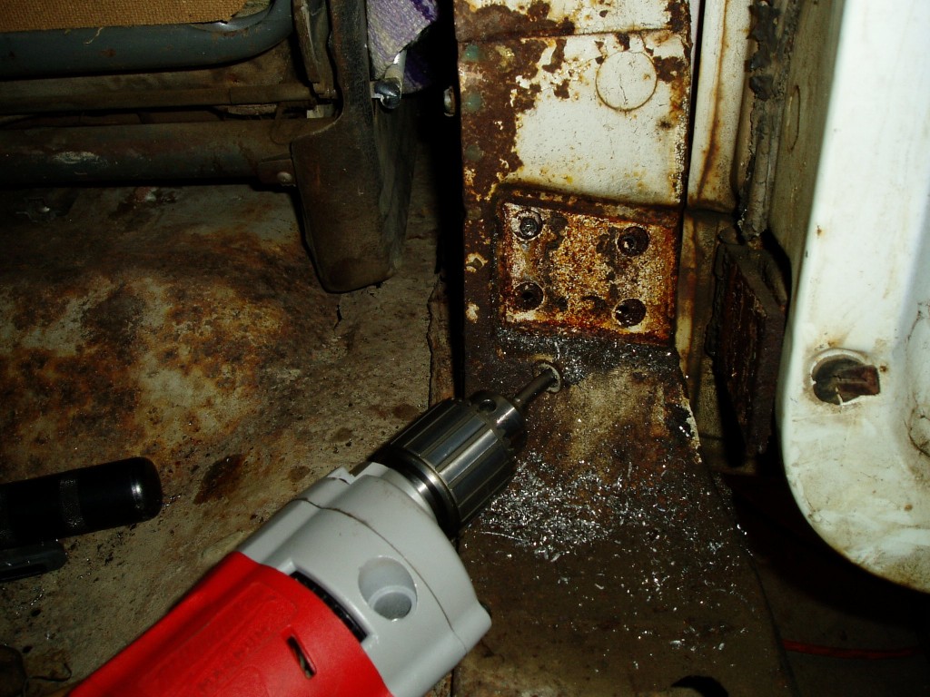 Saturday 3/3/2007. Drilling out the door bolts. Every last one was frozen solid.