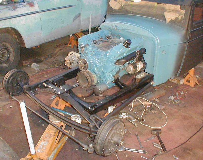 Motor, firewall, cowl, exhaust manifolds, beam, spring, and radius rods painted and installed.