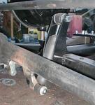 The new shock mounts, shocks, and revised bottom mounts on the radius rod. Concrete stake helped fill the gap between the actual