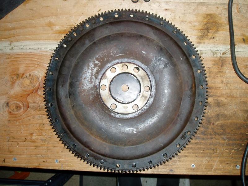Flywheel, engine side. It's 14.5" diameter. There are 30 bolt holes and 2 pegs along the outside.