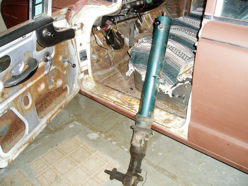 Sunday 2/19/2006. I removed the steering column and steering box. They come out through the hole in the floor as a unit. I had t