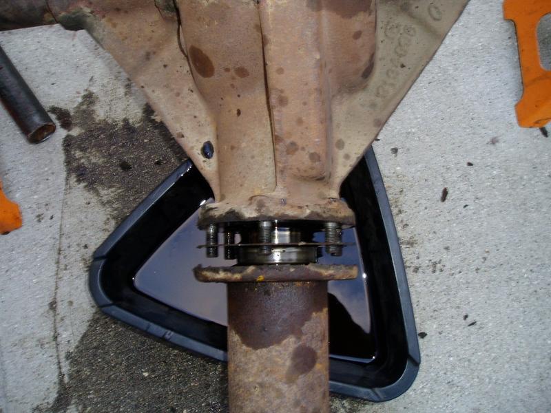 Sat 4/8/06. Torque tube to differential companion flange. The funky double lock washers are a pain.