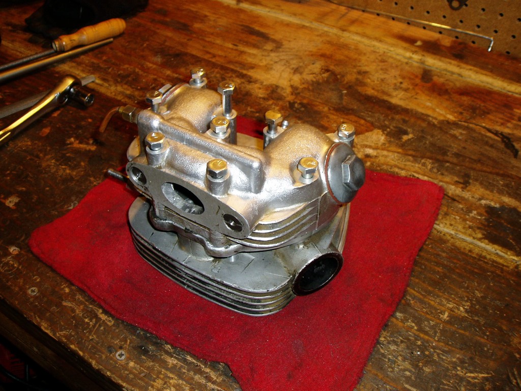 All rocker box studs are replaced by bolts. The holes in the head are all heli-colied. The bolts all thread in easy now, no more