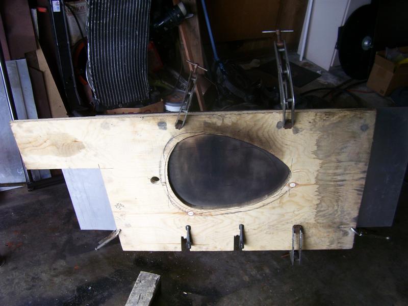 I made a pattern out of wood and clamped the part to it. I used a propane torch to anneal the aluminum to make it soft.